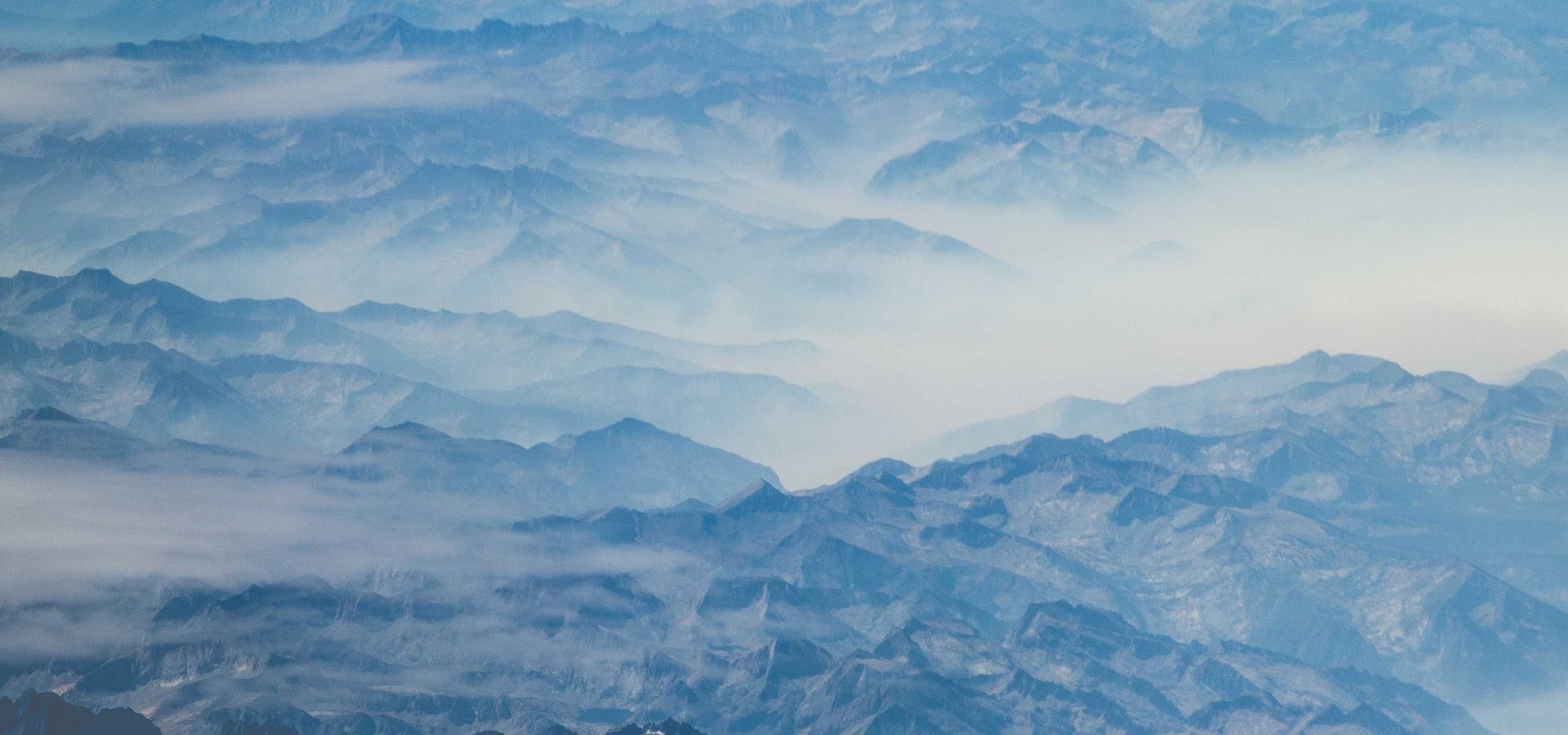 Layered blue mountain ridges in morning haze