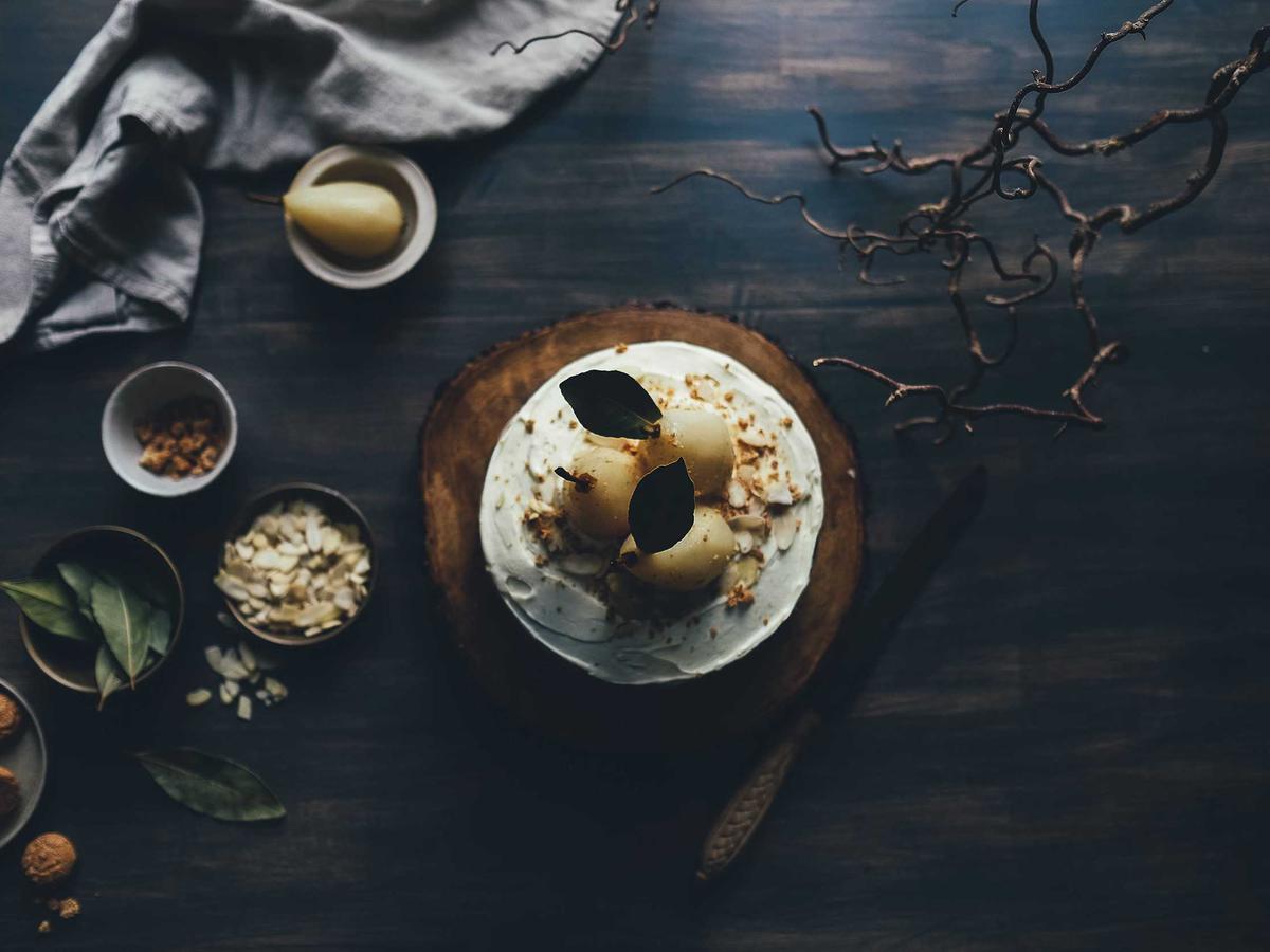 A dark table set with cake and figs
